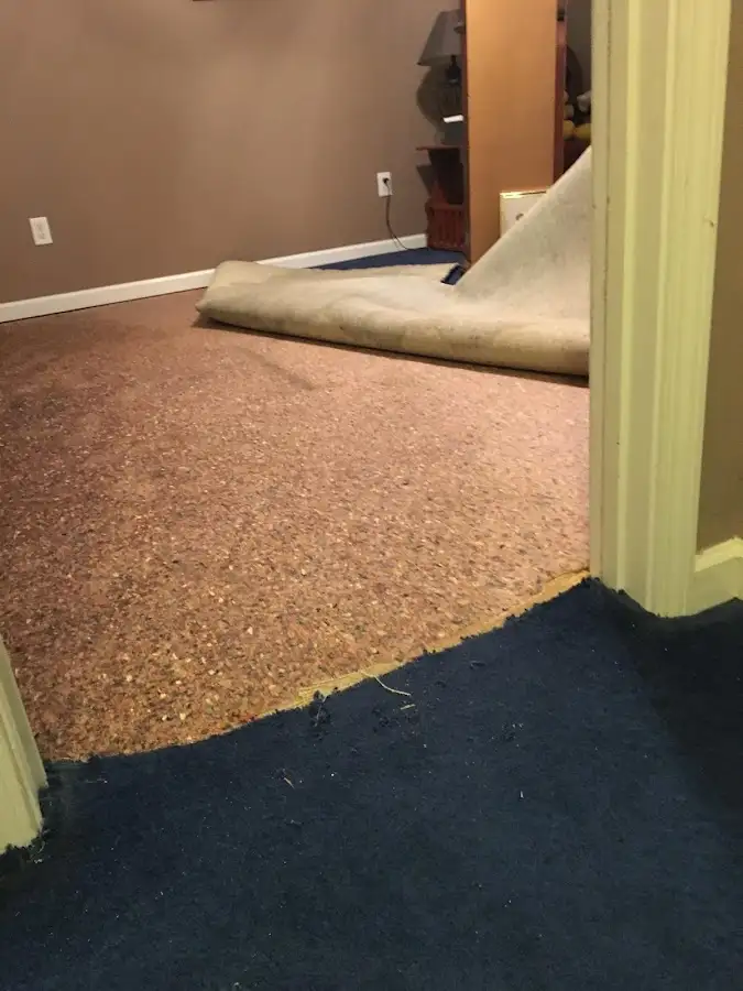 Carpet pad removal revealing water damage during Drying & Dehumidification in Decorah
